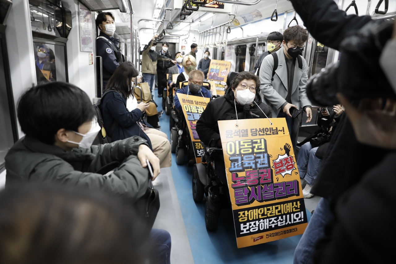 3월 29일 전국장애인차별철폐연대가 시위 잠정 중단 전 마지막 출근길 지하철 탑승 시위를 진행하고 있다. 사진 김수현 기자